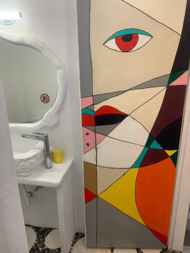 a bathroom with a painting of an eye on the door at Manello Home Art in Athens