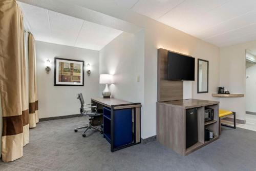 a hotel room with a desk and a tv at Comfort Inn Herndon-Reston in Herndon