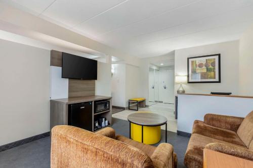 a living room with a couch and a table at Comfort Inn Herndon-Reston in Herndon