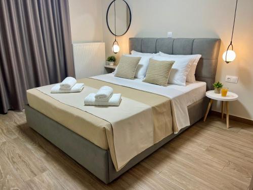 a bedroom with a large bed with towels on it at Cashmere axd in Alexandroupoli