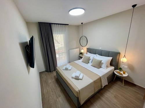 a bedroom with a large bed and a television at Cashmere axd in Alexandroupoli
