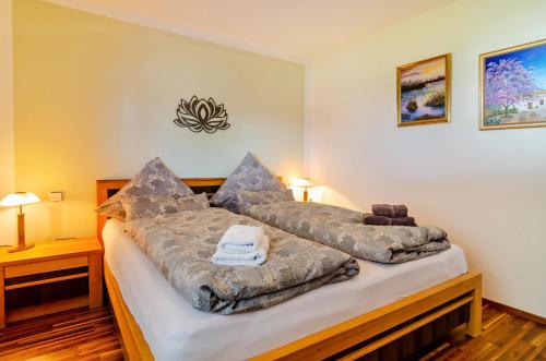 a bedroom with a bed covered in blankets at Fewo Wegen in Salem