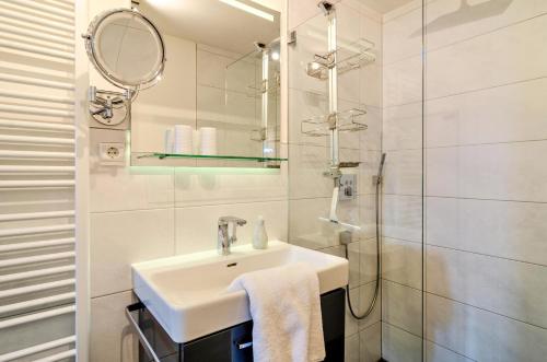 a white bathroom with a sink and a shower at Fewo Wegen in Salem