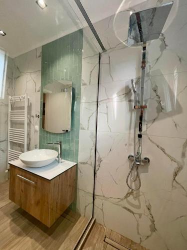 a bathroom with a sink and a shower at Cashmere axd in Alexandroupoli