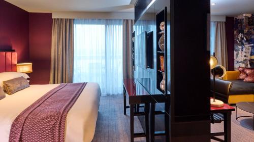 a hotel room with a bed and a desk at Malmaison Aberdeen in Aberdeen