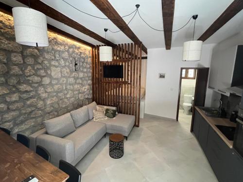 a living room with a couch and a table at The Oldest Street Apartment - TOSA in Risan