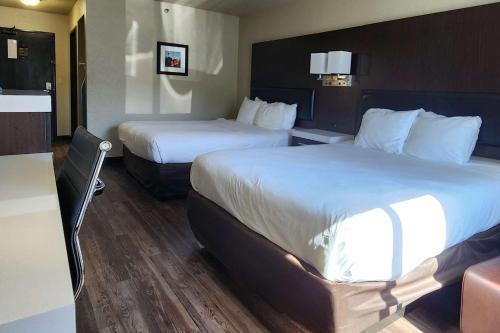 a hotel room with two beds and a kitchen at Comfort Inn & Suites Shakopee Downtown Area in Shakopee
