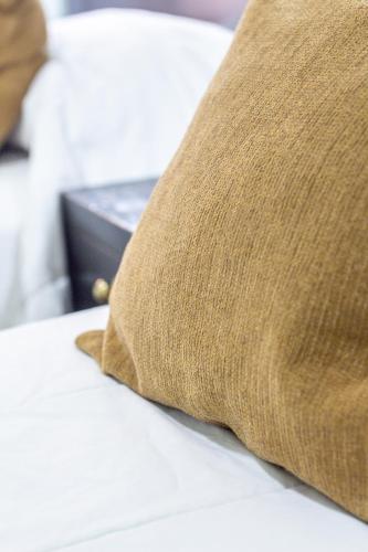 a pillow sitting on top of a bed at Gregorio I Hotel Boutique in San Salvador de Jujuy