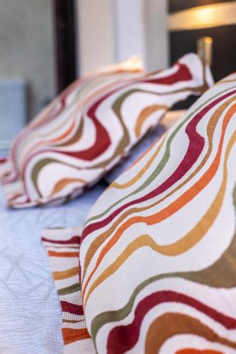 a row of pillows sitting on a bed at Gregorio I Hotel Boutique in San Salvador de Jujuy