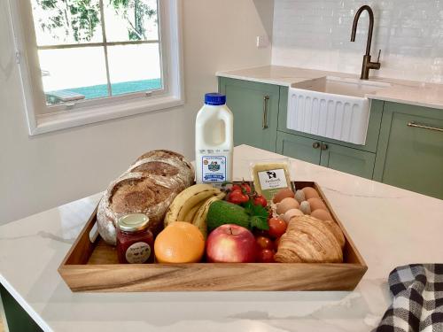 Een dienblad met eten op het aanrecht, met een fles melk ernaast. bij Parker Cottage in Maleny