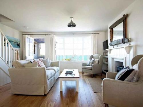 a living room with two couches and a coffee table at Castaway, Port Isaac Bay Holidays in Port Isaac