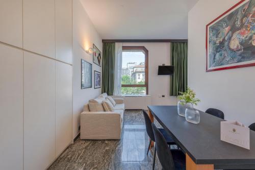 a living room with a table and a couch at Milan Royal Suites - Centro in Milan
