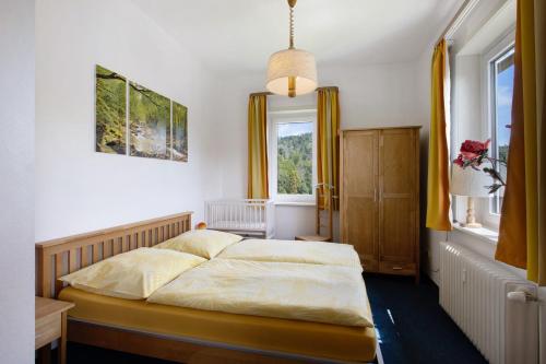 a bedroom with two beds and a window at Der Falkenhorst in Bad Sachsa