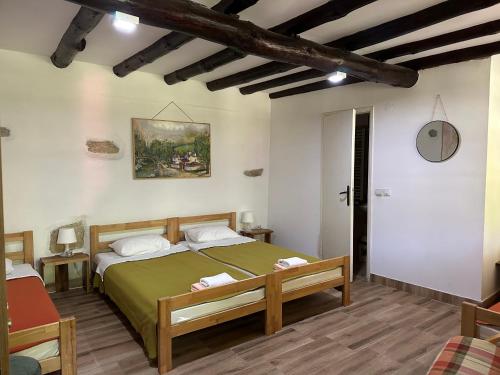 a bedroom with a large bed in a room at Konak Tosa in Poganovo