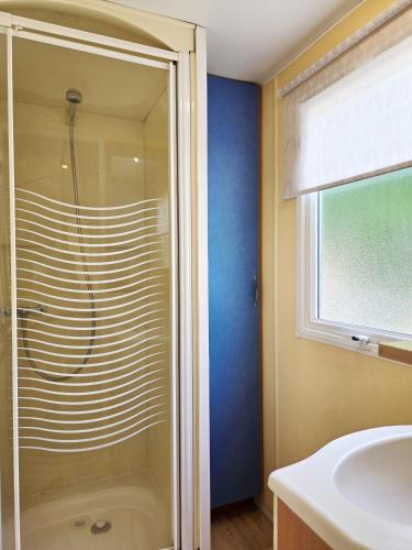 a bathroom with a shower and a sink at Camping Costa Dorada Bungalow Maia in Canet de Mar