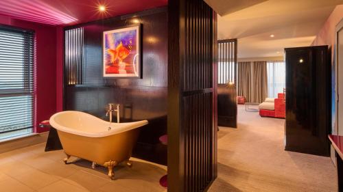 a bathroom with a bath tub in a room at Malmaison Aberdeen in Aberdeen