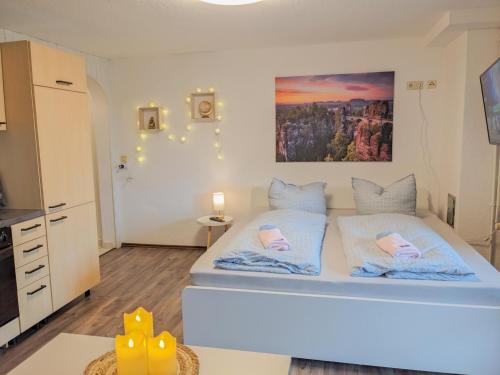 a bedroom with a large bed in a room at B2 - Urlaubsmagie - mit Terrasse& Grill direkt am Wanderweg in Sebnitz