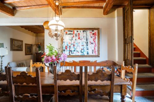 a dining room with a table with flowers on it at Casa Marcello in Vinci