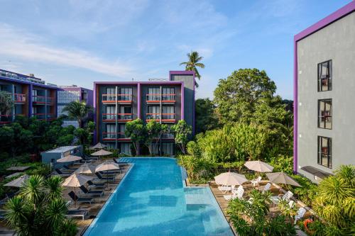 an aerial view of a hotel with a swimming pool and umbrellas at Holiday Inn Express Phuket Patong Beach Central by IHG in Patong Beach