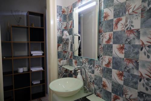 a bathroom with a sink and a toilet and a mirror at B&B Villa Pallante in Bari