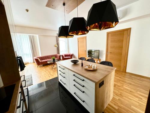 a kitchen with a island in the middle of a room at Spacious Family Apartment by the Sea in Jūrmala