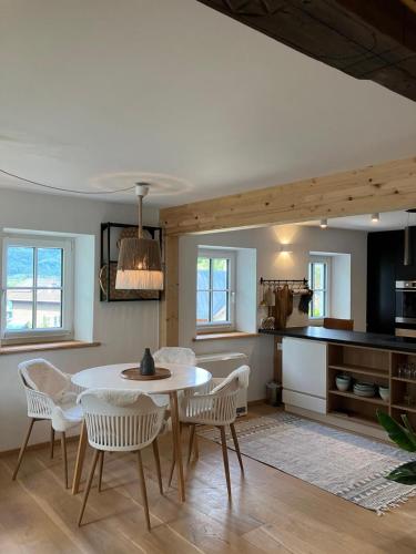 a kitchen and dining room with a table and chairs at Anno 1763 in St. Wolfgang