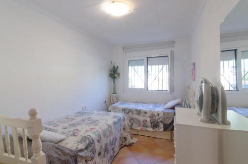 a bedroom with two beds and a window at Club Villamar - Filo in Maçanet de la Selva