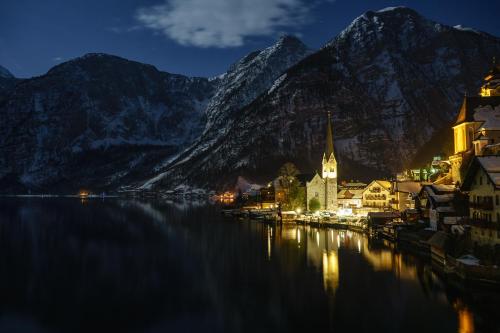 a town on the water in front of a mountain at Ferienwohnung SeeTraum Hallstatt in Hallstatt