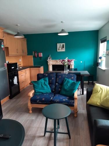 a living room with a blue couch and a table at StaySligo Apartment in Sligo