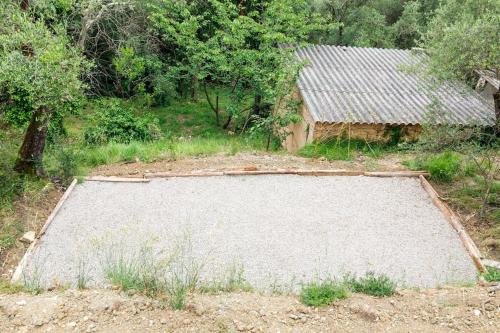 an empty field with a building in the background at Bastide Provençale,Piscine in Cabris