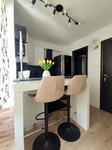 a kitchen with a white desk and two chairs at Guest House Exalto in Trogir
