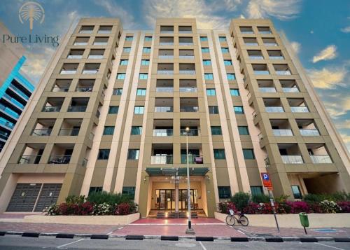 a large building with the front of it at Modern living nestled with 1BR_Silicon Oasis Dubai in Dubai