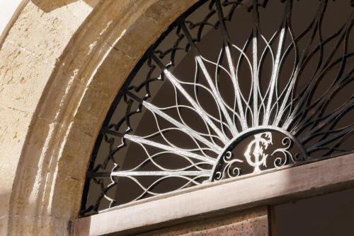 a iron door with a metal design on it at Dimora SIQU in Menfi