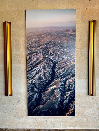 a picture hanging on a wall with two pipes at Very Peri Cappadocia - The Lifestyle Luxury Design Hotel in Uchisar