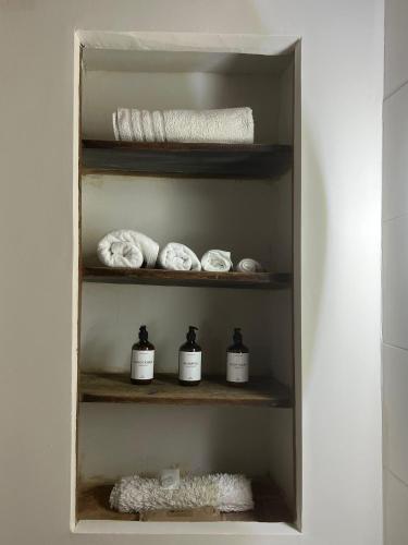 a closet with three shelves with towels in it at Casa Nicola in Toro