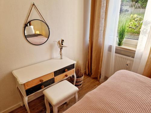 a bedroom with a mirror and a dresser and a bed at Sonnenhang im Boho-Stil mit Balkon, 500m zum See, 2 Schlafzimmer in Möhnesee