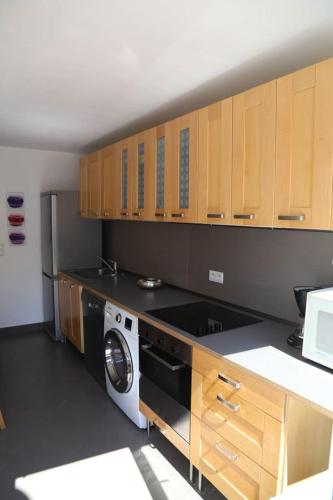 Il comprend une cuisine équipée d'un lave-linge et de placards en bois. dans l'établissement Maison pecheur rénovée au centre de Trouville, à Trouville-sur-Mer