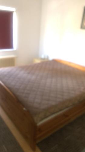 a bed with a wooden frame in a room at Smjestaj Glamoč in Glamoč