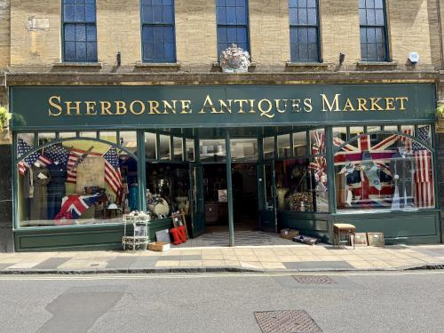 a store front of a store with american flags in it at Priors Oak - A Cosy Studio with Countryside Views in Dorset in Stalbridge
