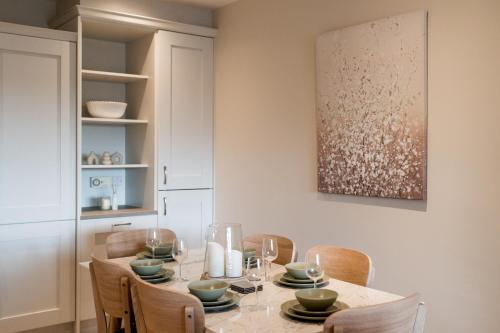 a dining room with a table and chairs at No.3 Mill Park a luxury self-catering apartment in Donegal