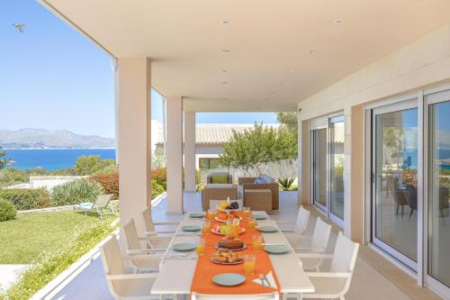 an outdoor dining room with a table and chairs at Villa Garau / Heura 8 in Alcudia