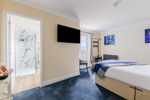 a hotel room with a bed and a large window at Loch Ness Clansman Hotel in Drumnadrochit