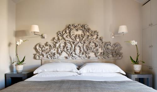 a bed with a large ornate headboard in a bedroom at Casa Montani in Rome