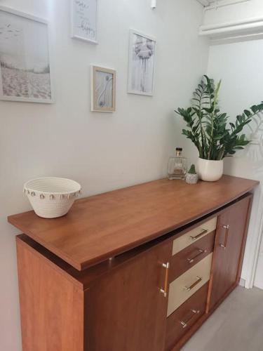 a wooden counter with a bowl and a plant on it at La Maison JAUNE in Die