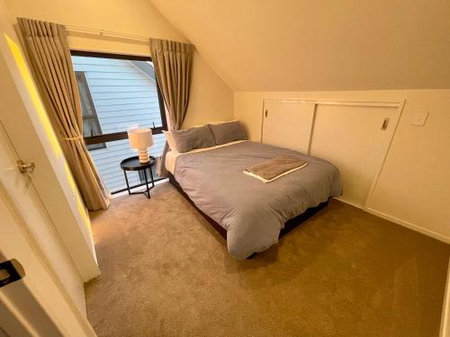 a small bedroom with a bed and a window at Free carpark, 4-bedroom house in Auckland