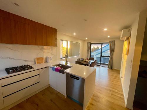 a kitchen with a sink and a stove at Free carpark, 4-bedroom house in Auckland