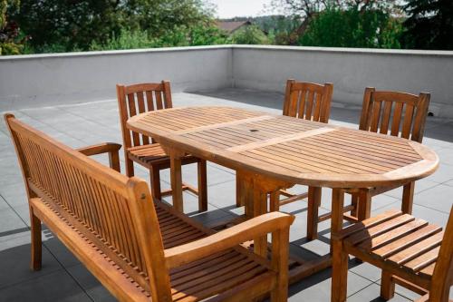 a wooden table and chairs on a patio at vila Karolína in Havlickuv Brod