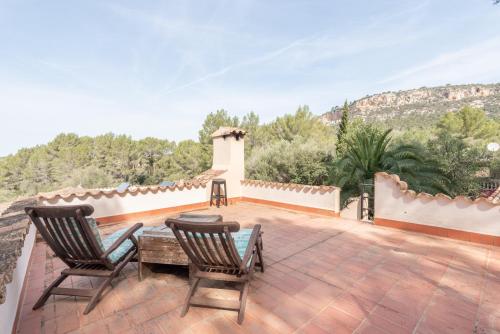 a patio with two chairs and a table on a roof at Casa Vista Monte in Llucmajor