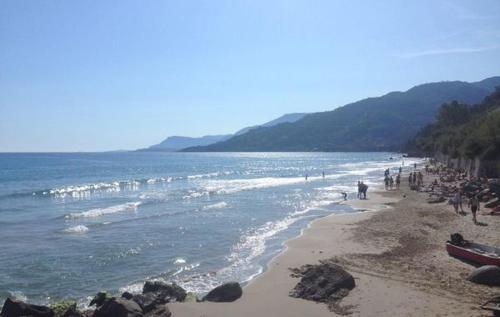 a group of people on a beach with the ocean at Principessa Grace Apartment Isolabona Italy Sleeps 3 in Isolabona