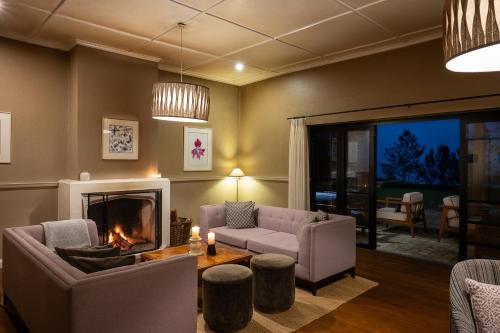 a living room with a couch and a fireplace at Goatfell - Nuwara Eliya in Kandapola